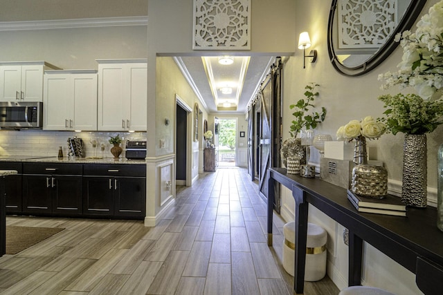 interior space featuring light wood-style flooring and ornamental molding