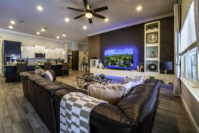 living area featuring crown molding, wood finished floors, ceiling fan, and recessed lighting