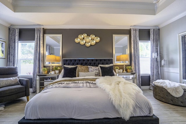 bedroom featuring ornamental molding, a wainscoted wall, and wood finished floors
