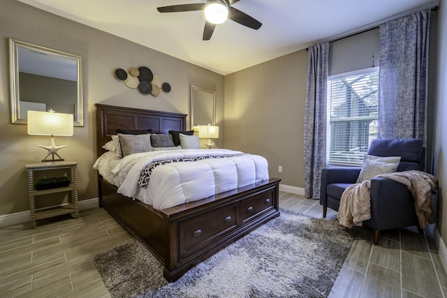 bedroom with baseboards, a ceiling fan, and wood finish floors