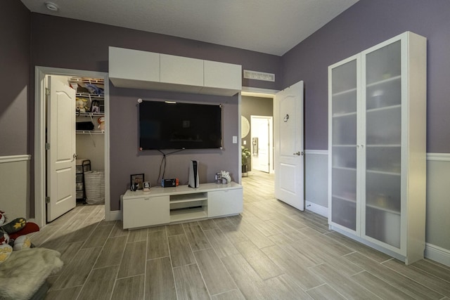 living area featuring baseboards and wood finish floors