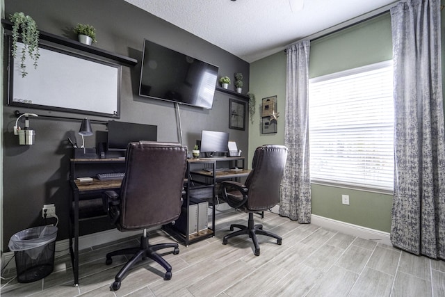 office featuring baseboards, a textured ceiling, and wood finish floors