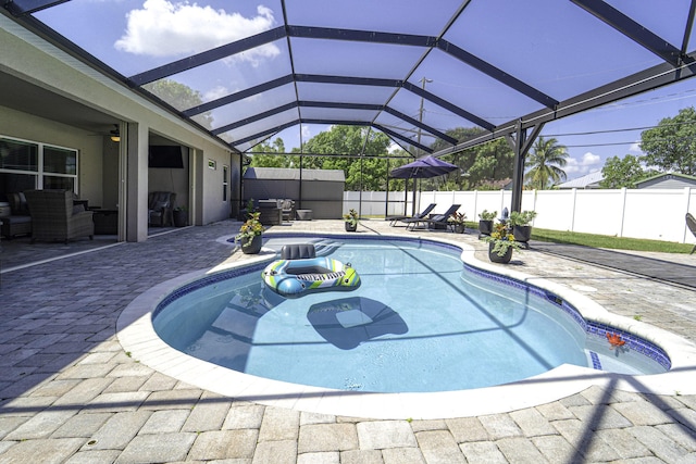 view of pool with a patio, an outdoor living space, a fenced backyard, a fenced in pool, and glass enclosure