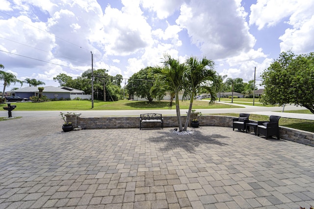 view of home's community featuring a yard and a patio