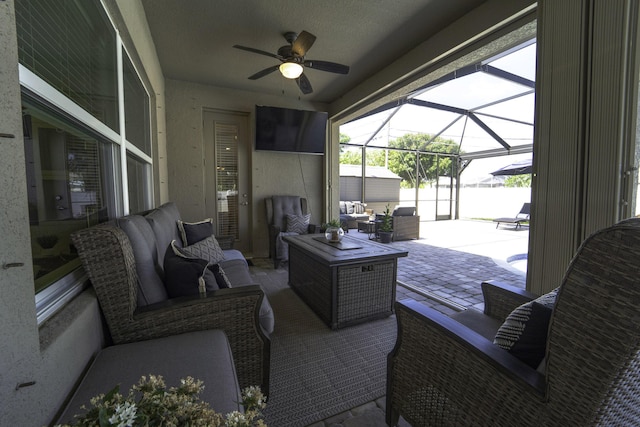 view of patio with an outdoor hangout area, a ceiling fan, and a lanai