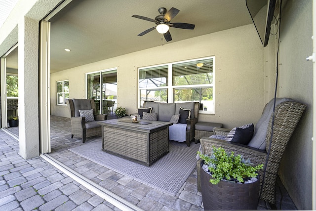 view of patio with ceiling fan and an outdoor living space