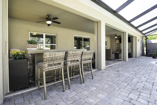 view of patio / terrace featuring a lanai and a ceiling fan