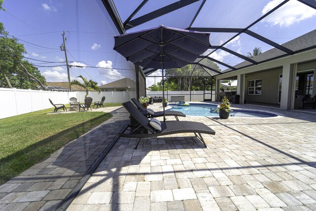 6920 NW Jorgensen Rd, Port Saint Lucie, FL 34983 - view of patio / terrace featuring an outdoor fire pit and a lanai