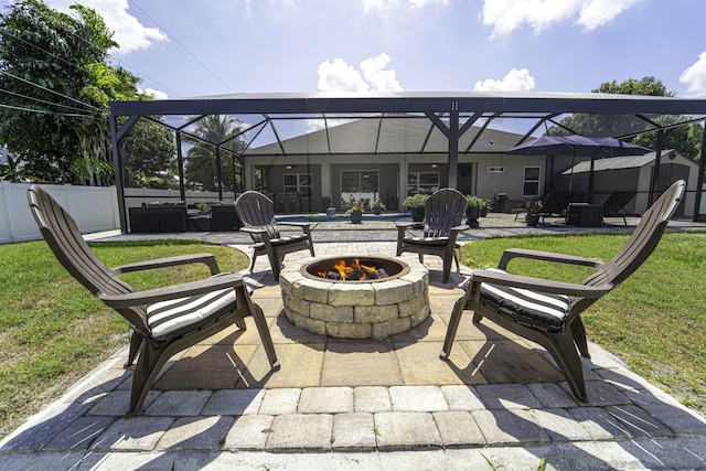view of patio / terrace with an outdoor living space with a fire pit and glass enclosure