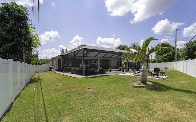 back of house with a fenced backyard, a patio, and a lawn