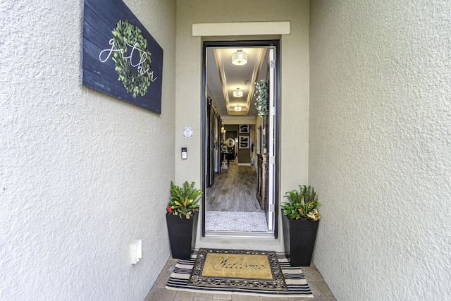entrance to property featuring stucco siding