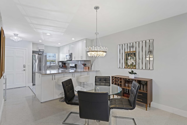 701 NE Harbour Ter Unit 103, Boca Raton, FL 33431 - dining room with a chandelier, dark aggregate flooring, baseboards, and recessed lighting
