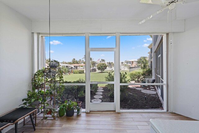 701 NE Harbour Ter Unit 103, Boca Raton, FL 33431 - unfurnished sunroom featuring wood finished floors and a residential view