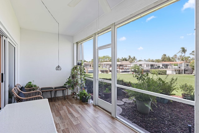 701 NE Harbour Ter Unit 103, Boca Raton, FL 33431 - sunroom / solarium with wood finished floors and a residential view