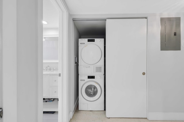 701 NE Harbour Ter Unit 103, Boca Raton, FL 33431 - laundry area featuring electric panel and stacked washer / drying machine