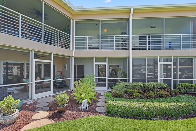 701 NE Harbour Ter Unit 103, Boca Raton, FL 33431 - back of property featuring stucco siding and a sunroom