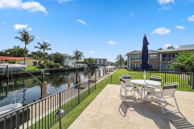 701 NE Harbour Ter Unit 103, Boca Raton, FL 33431 - view of patio with a water view, a residential view, and outdoor dining space