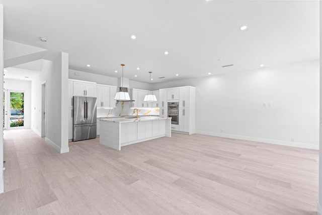 126 Auburn Dr, Lake Worth Beach, FL 33460 - kitchen featuring white cabinetry, stainless steel appliances, an island with sink, and open floor plan