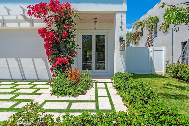 126 Auburn Dr, Lake Worth Beach, FL 33460 - property entrance with fence, stucco siding, and french doors