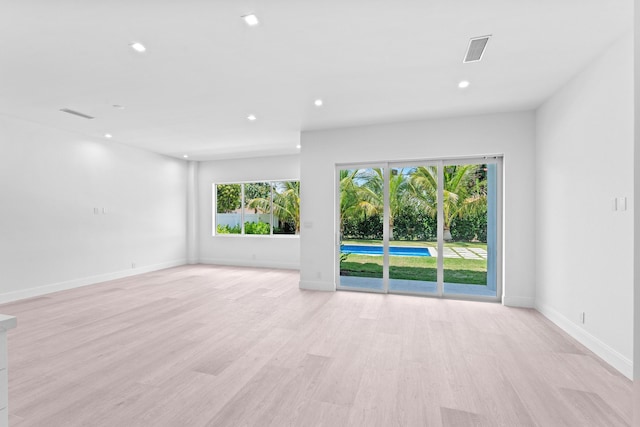 126 Auburn Dr, Lake Worth Beach, FL 33460 - unfurnished living room with light wood finished floors, baseboards, visible vents, and recessed lighting