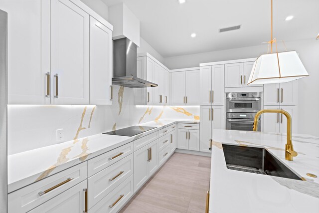126 Auburn Dr, Lake Worth Beach, FL 33460 - kitchen with a sink, stainless steel double oven, visible vents, wall chimney exhaust hood, and black electric cooktop