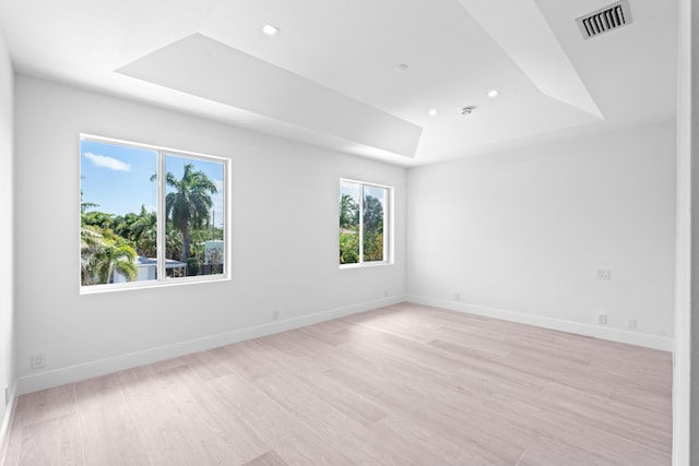 126 Auburn Dr, Lake Worth Beach, FL 33460 - unfurnished room with baseboards, a raised ceiling, light wood-style floors, and visible vents