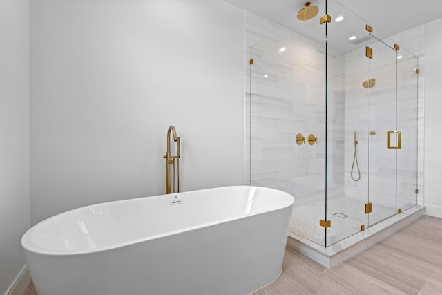 126 Auburn Dr, Lake Worth Beach, FL 33460 - full bathroom with a freestanding bath, baseboards, a shower stall, and wood finished floors