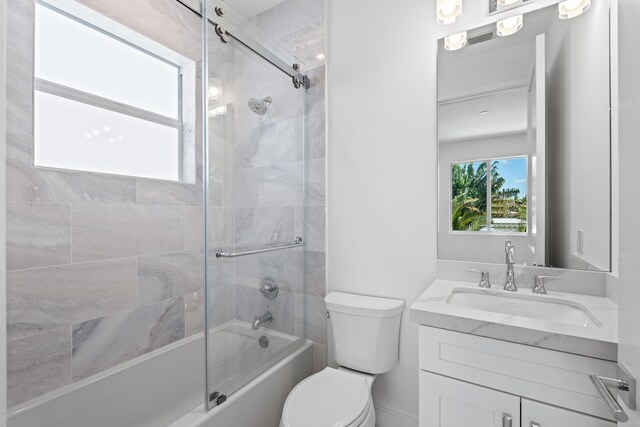 126 Auburn Dr, Lake Worth Beach, FL 33460 - bathroom with vanity, toilet, and combined bath / shower with glass door