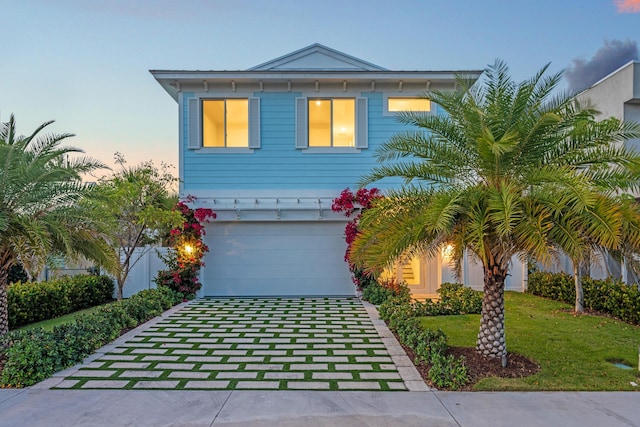 126 Auburn Dr, Lake Worth Beach, FL 33460 - view of front facade with a front lawn, driveway, and a garage