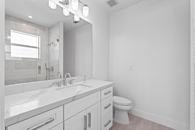 126 Auburn Dr, Lake Worth Beach, FL 33460 - bathroom with toilet, wood finished floors, a stall shower, visible vents, and baseboards