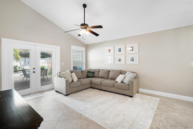 living room with a wealth of natural light, french doors, ceiling fan, and high vaulted ceiling