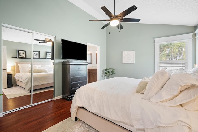 bedroom featuring a closet, high vaulted ceiling, dark wood finished floors, a ceiling fan, and connected bathroom