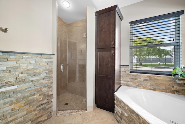 full bath featuring a garden tub, tile patterned flooring, and a shower stall