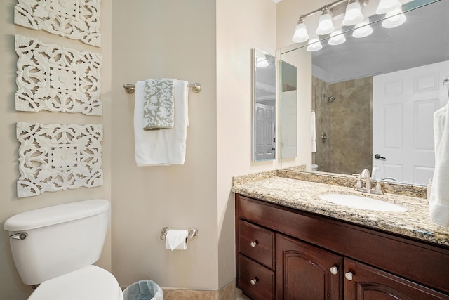 full bathroom with vanity, toilet, and a tile shower