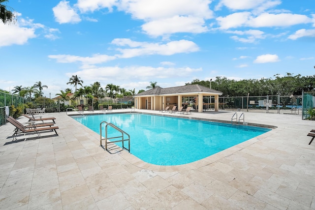 pool featuring a patio and fence