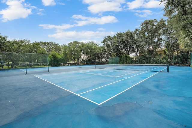 view of sport court featuring fence
