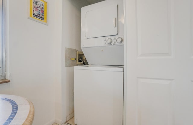 14360 Strathmore Ln Unit 404, Delray Beach, FL 33446 - laundry room featuring baseboards, laundry area, and stacked washer and clothes dryer