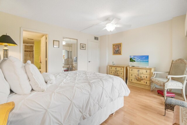 14360 Strathmore Ln Unit 404, Delray Beach, FL 33446 - bedroom featuring ensuite bathroom, a ceiling fan, visible vents, and wood finished floors