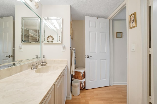 14360 Strathmore Ln Unit 404, Delray Beach, FL 33446 - bathroom featuring vanity, a textured ceiling, and wood finished floors