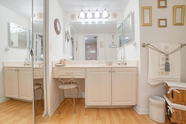 14360 Strathmore Ln Unit 404, Delray Beach, FL 33446 - full bath featuring baseboards, vanity, a textured ceiling, and wood finished floors
