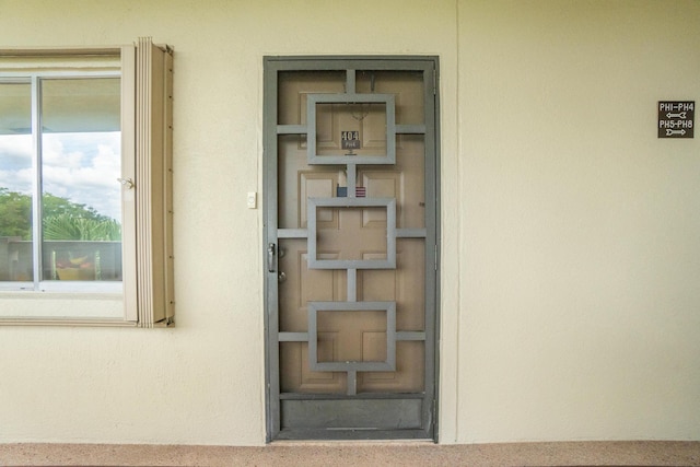 14360 Strathmore Ln Unit 404, Delray Beach, FL 33446 - view of exterior entry with stucco siding
