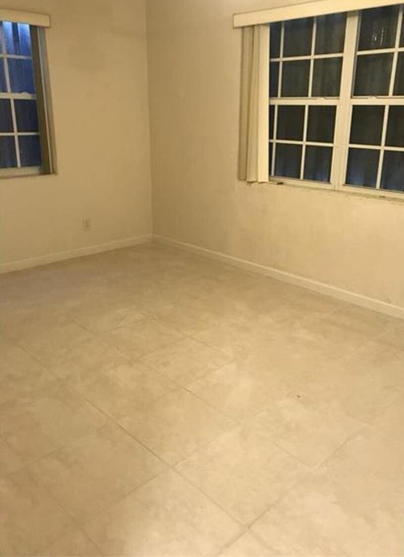 unfurnished room featuring baseboards