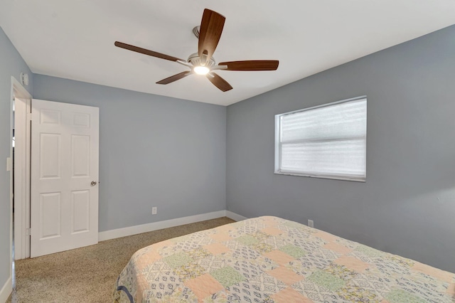 carpeted bedroom with baseboards and ceiling fan