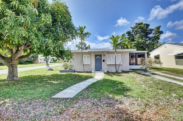 view of front facade featuring stucco siding and a front lawn