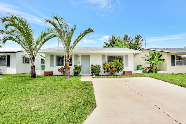 4902 NW 27th Way, Tamarac, FL 33309 - ranch-style home with stucco siding, a front yard, and driveway