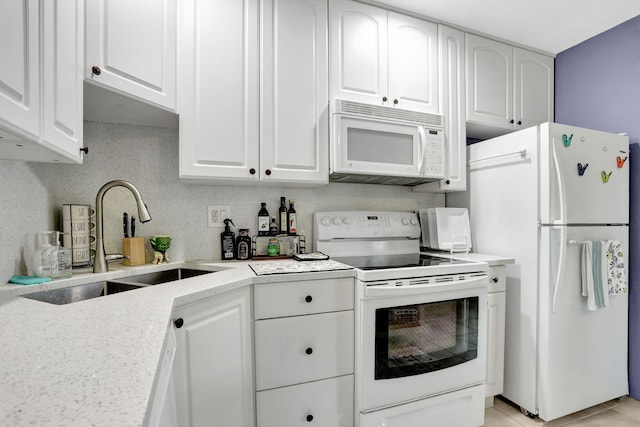 4902 NW 27th Way, Tamarac, FL 33309 - kitchen featuring white appliances and white cabinetry
