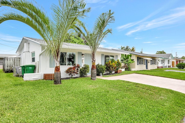 4902 NW 27th Way, Tamarac, FL 33309 - ranch-style house featuring a front yard and stucco siding
