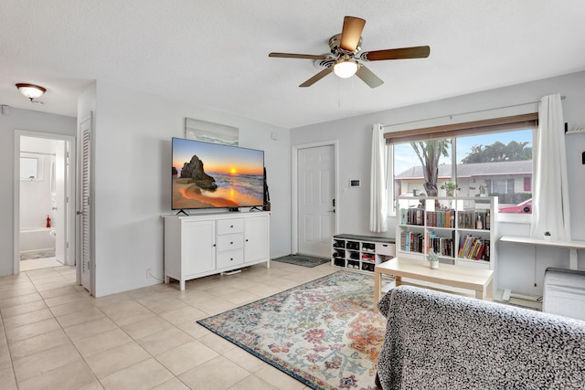4902 NW 27th Way, Tamarac, FL 33309 - living area with a ceiling fan, light tile patterned floors, and a textured ceiling