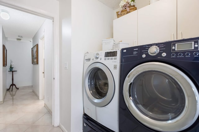 650 NW 48th Ave, Coconut Creek, FL 33063 - washroom featuring washing machine and clothes dryer, cabinet space, baseboards, and light tile patterned floors