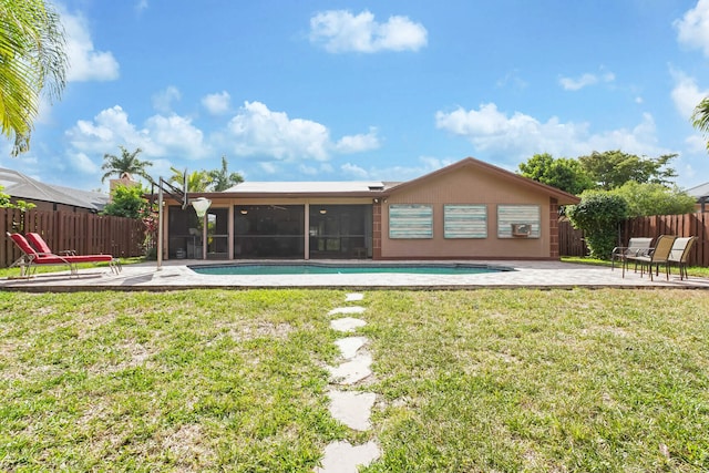 650 NW 48th Ave, Coconut Creek, FL 33063 - rear view of property with a fenced backyard, a sunroom, a patio, and a yard